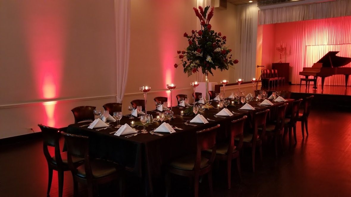 The Old Eagle Room bathed in candlelight and warm uplighting